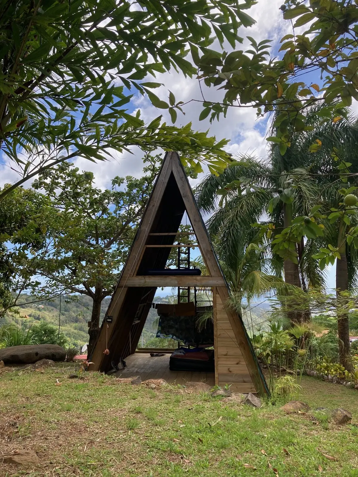 Panoramic view of Les Vendredis domain with A-frame, hills and tropical garden