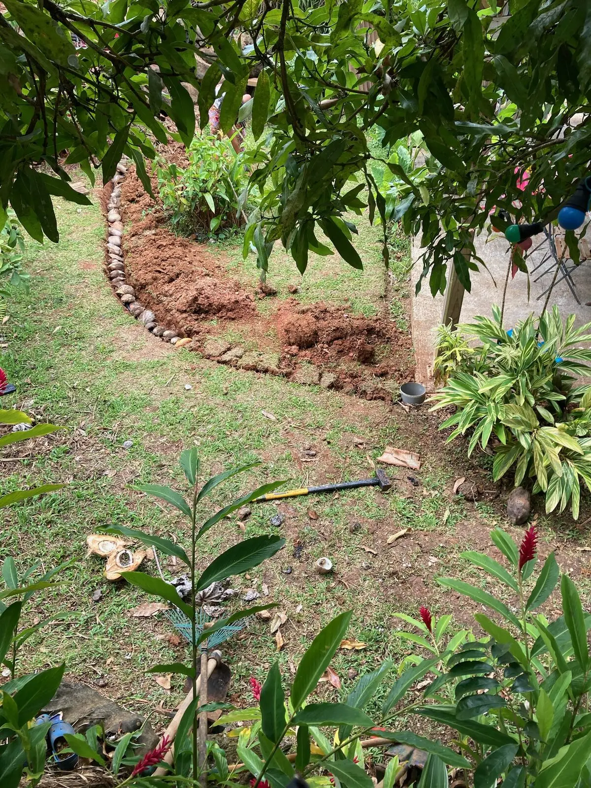 The trench line along the stone wall, finished — Les Vendredis garden, Sainte-Luce